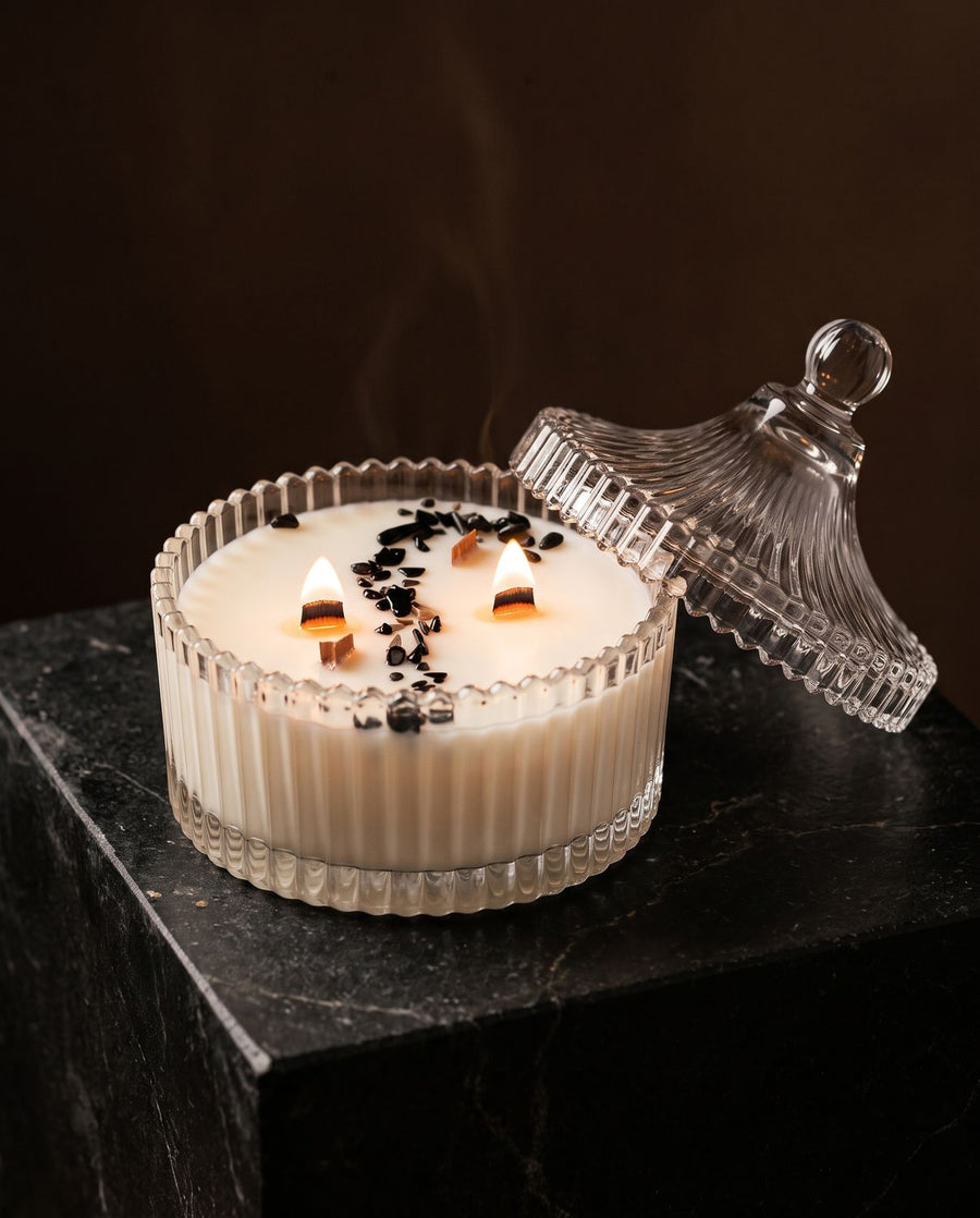 Healing
 candle by Lili & Koi, Amber & Lavender
, lit on dark stone